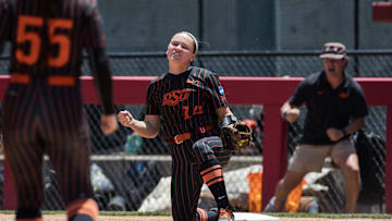 May 17, 2025; Fayetteville, AR, USA;  Oklahoma State Cowgirls infielder Karli Godwin (14) reacts to making a play at first for an out during the fourth inning against the Arkansas Lady Razorbacks.  Mandatory Credit: Brett Rojo-Imagn Images