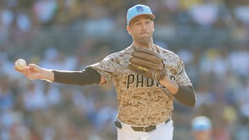 Jul 4, 2025; San Diego, California, USA; San Diego Padres relief pitcher Jason Adam (40) throws to first base to pick off Texas Rangers center fielder Evan Carter (32) during the eighth inning at Petco Park. Mandatory Credit: David Frerker-Imagn Images