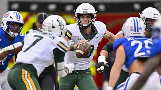 Baylor Bears quarterback Sawyer Robertson (13) looks to pass the ball to running back Bryson Washington (7) 