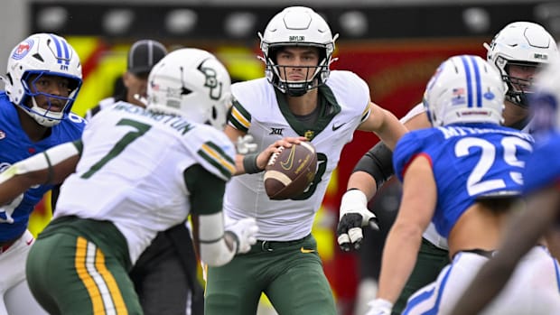 Baylor Bears quarterback Sawyer Robertson (13) looks to pass the ball to running back Bryson Washington (7)