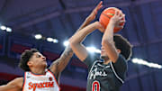 Dec 11, 2025; Syracuse, New York, USA; Syracuse Orange guard Kiyan Anthony (7) blocks the shot of Saint Joseph's Hawks guard Derek Simpson (0) during the first half at the JMA Wireless Dome. Mandatory Credit: Rich Barnes-Imagn Images