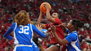 Louisville's guard Tajianna Roberts (22) makes the basket against Kentucky's forward Amelia Hassett (32) and guard Jordan Obi (0) in the KFC Yum! Center. 
November 22, 2025