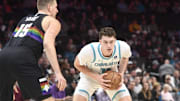 Dec 7, 2025; Charlotte, North Carolina, USA; Charlotte Hornets center Ryan Kalkbrenner (11) looks to pass during the first half against the Denver Nuggets at the Spectrum Center. Mandatory Credit: Sam Sharpe-Imagn Images