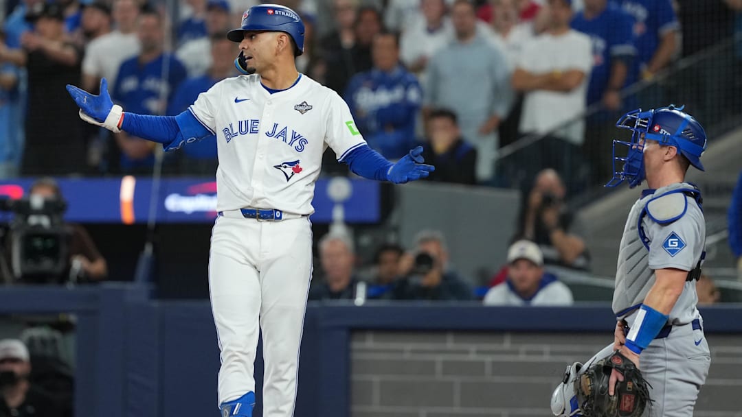 Nov 1, 2025; Toronto, Ontario, CAN; Toronto Blue Jays second basemen Andres Gimenez (0) reacts after being hit by a pitch in the fourth inning for game seven of the 2025 MLB World Series at Rogers Centre. Mandatory Credit: Nick Turchiaro-Imagn Images