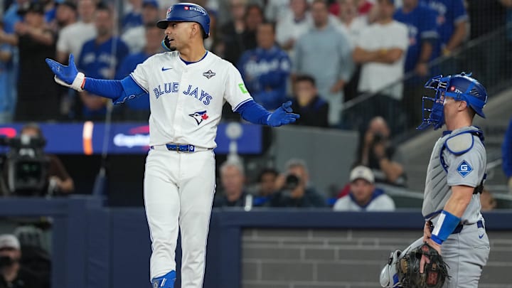 Nov 1, 2025; Toronto, Ontario, CAN; Toronto Blue Jays second basemen Andres Gimenez (0) reacts after being hit by a pitch in the fourth inning for game seven of the 2025 MLB World Series at Rogers Centre. Mandatory Credit: Nick Turchiaro-Imagn Images