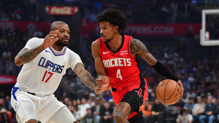 Apr 14, 2024; Los Angeles, California, USA;  h43 moves the ball against Los Angeles Clippers forward P.J. Tucker (17) during the first half at Crypto.com Arena. Mandatory Credit: Gary A. Vasquez-USA TODAY Sports