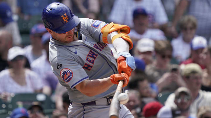 Jun 22, 2024; Chicago, Illinois, USA; New York Mets first baseman Pete Alonso (20) hits a single against the Chicago Cubs during the sixth inning at Wrigley Field. 