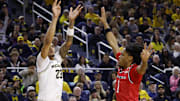 Dec 6, 2025; Ann Arbor, Michigan, USA;  Michigan Wolverines forward Yaxel Lendeborg (23) shoots on Rutgers Scarlet Knights guard Jamichael Davis (1) in the first half at Crisler Center. Mandatory Credit: Rick Osentoski-Imagn Images