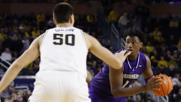 Jan 12, 2025; Ann Arbor, Michigan, USA; Washington Huskies forward Great Osobor (1) inn Michigan Wolverines center Vladislav Goldin (50) in the second half at Crisler Center. Mandatory Credit: Rick Osentoski-Imagn Images