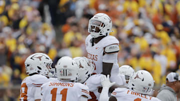 Sep 7, 2024; Ann Arbor, Michigan, USA; Texas Longhorns defensive back Derek Williams Jr. (2) celebrates with teammates after making an interception in the second half am at Michigan Stadium. Mandatory Credit: Rick Osentoski-Imagn Images