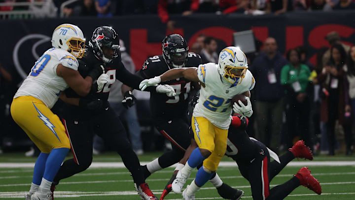 Jan 11, 2025; Houston, Texas, USA; Los Angeles Chargers running back J.K. Dobbins (27) runs the ball during the first quarter against the Houston Texans in the first quarter in an AFC wild card game at NRG Stadium. Mandatory Credit: Thomas Shea-Imagn Images