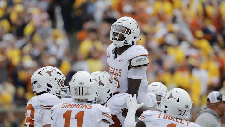 Sep 7, 2024; Ann Arbor, Michigan, USA; Texas Longhorns defensive back Derek Williams Jr. (2) celebrates with teammates after making an interception in the second half am at Michigan Stadium. Mandatory Credit: Rick Osentoski-Imagn Images