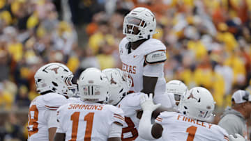 Texas Longhorns defensive back Derek Williams Jr. celebrates with teammates after making an interception against the Michigan Wolverines.