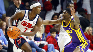 Jan 11, 2025; Oxford, Mississippi, USA; Mississippi Rebels guard Davon Barnes (7) handles the ball as LSU Tigers guard Cam Carter (5) defends during the first half at The Sandy and John Black Pavilion at Ole Miss. Mandatory Credit: Petre Thomas-Imagn Images