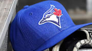 Apr 16, 2025; Toronto, Ontario, CAN; A Toronto Blue Jays hat and glove in the dugout during a game against the Atlanta Braves at Rogers Centre.