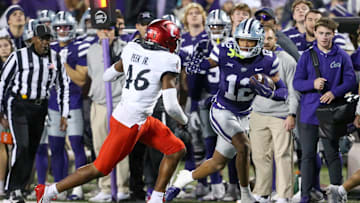 Nov 23, 2024; Manhattan, Kansas, USA; Kansas State Wildcats wide receiver Tre Spivey (12) looks for room to run against Cincinnati Bearcats linebacker Antwan Peek Jr. (46) during the fourth quarter at Bill Snyder Family Football Stadium. Mandatory Credit: Scott Sewell-Imagn Images