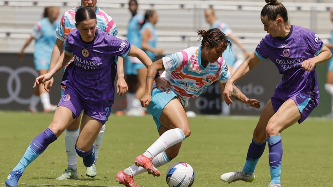 Mar 29, 2025; Orlando, Florida, USA; Orlando Pride midfielder Haley McCutcheon (left) and midfielder Morgan Gautrat (right) close in on San Diego Wave FC forward Gia Corley (11) during the first half at Inter&Co Stadium. Mandatory Credit: Reinhold Matay-Imagn Images