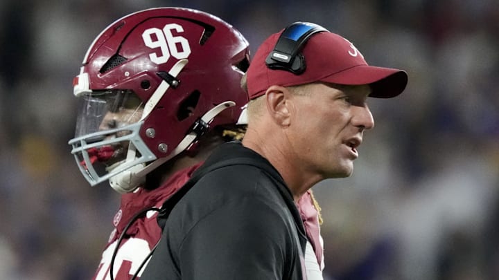 Alabama head coach Kalen DeBoer goes out to congratulate players coming off the field as Alabama defensive lineman Tim Keenan III (96)
