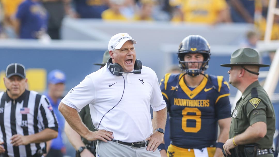 Sep 13, 2025; Morgantown, West Virginia, USA; West Virginia Mountaineers head coach Rich Rodriguez yells at the referee during the second quarter against the Pittsburgh Panthers at Milan Puskar Stadium. Mandatory Credit: Ben Queen-Imagn Images