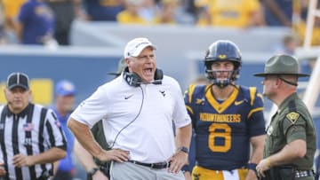 Sep 13, 2025; Morgantown, West Virginia, USA; West Virginia Mountaineers head coach Rich Rodriguez yells at the referee during the second quarter against the Pittsburgh Panthers at Milan Puskar Stadium. Mandatory Credit: Ben Queen-Imagn Images