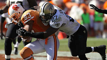 October 21, 2012; Tampa, FL, USA; New Orleans Saints free safety Malcolm Jenkins (27) tackles Tampa Bay Buccaneers wide receiver Vincent Jackson (83) during the second half at Raymond James Stadium. New Orleans Saints defeated the Tampa Bay Buccaneers 35-28. Mandatory Credit: Kim Klement-Imagn Images