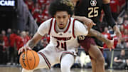 Feb 22, 2025; Louisville, Kentucky, USA;  Louisville Cardinals guard Chucky Hepburn (24) dribbles against Florida State Seminoles guard Justin Thomas (25) during the second half at KFC Yum! Center. Louisville defeated Florida State 89-81.