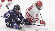 Wisconsin's Marianne Picard (18) fights for the puck after a faceoff with St. Thomas' Brieja Parent on Saturday March 2, 2024 at LaBahn Arena in Madison, Wisconsin.