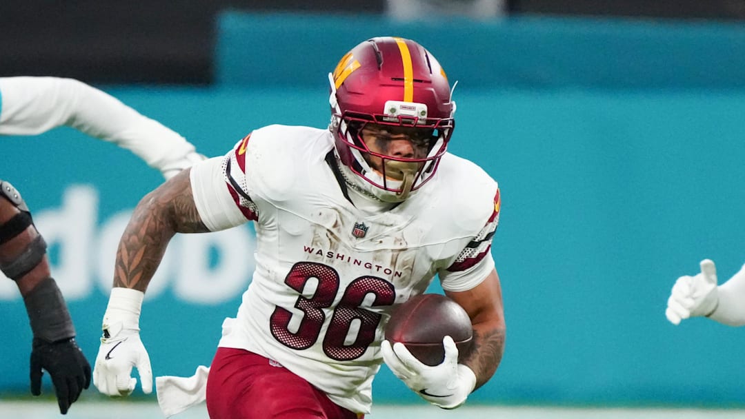 Nov 16, 2025; Madrid, Spain; Washington Commanders running back Chris Rodriguez Jr. (36) carries the ball against the Miami Dolphins in the second quarter during the 2025 NFL Madrid Game at Santiago Bernabeu Stadium. Mandatory Credit: Kirby Lee-Imagn Images