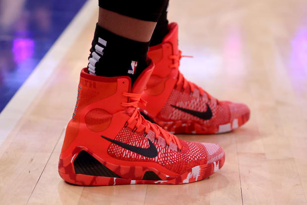 DeMar DeRozan wears red and black Nike Kobe sneakers.