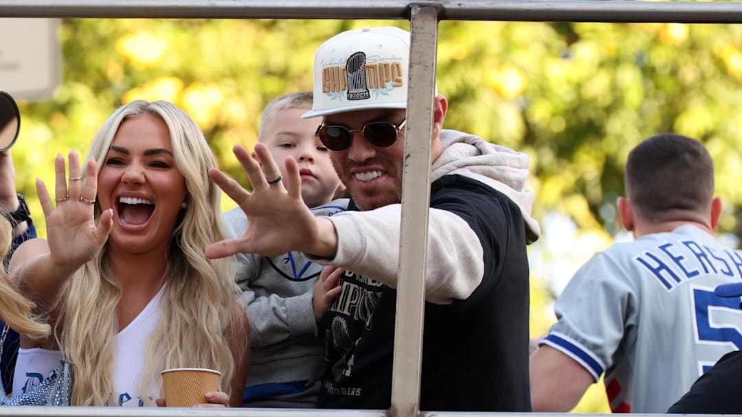  Los Angeles Dodgers first base Freddie Freeman (right) celebrates with his wife Chelsea Freeman during the 2024 World Series Championship parade in downtown Los Angeles. 