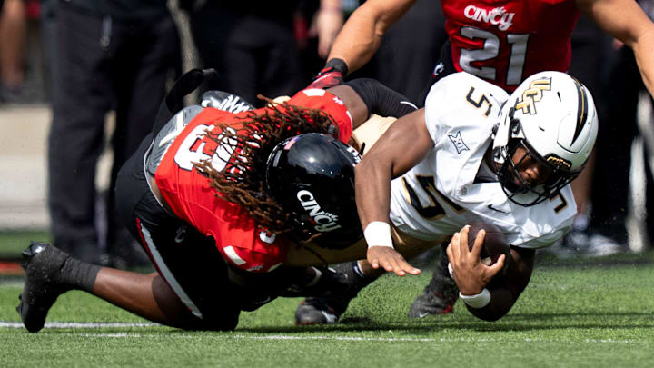 Cincinnati Bearcats safety Kye Stokes (3) tackles UCF Knights running back Jaden Nixon (5) in the second quarter of the NCAA football game between the Cincinnati Bearcats and UCF Knights at Nippert Stadium in Cincinnati on Oct. 11, 2025.