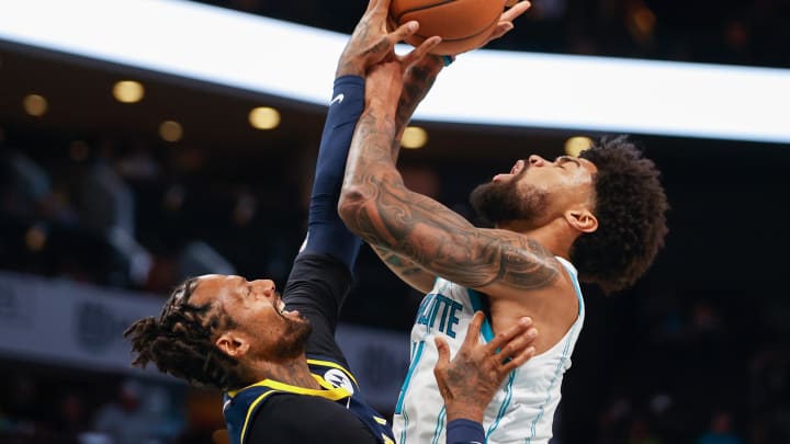 Oct 5, 2022; Charlotte, North Carolina, USA; Charlotte Hornets center Nick Richards (4) shoots against Indiana Pacers forward James Johnson in the second half at Spectrum Center. The Indiana Pacers won 122-97. Mandatory Credit: Nell Redmond-USA TODAY Sports