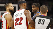Nov 24, 2021; Minneapolis, Minnesota, USA; Miami Heat forward Jimmy Butler (22) and Minnesota Timberwolves forward Anthony Edwards (1) exchange some actions before each receiving a technical foul in the third quarter as referee Andy Nagy (83) and forward Caleb Martin (16) step in at Target Center. Mandatory Credit: Bruce Kluckhohn-Imagn Images