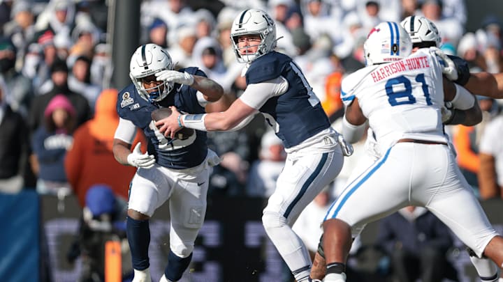 Penn State Nittany Lions quarterback Drew Allar hands the ball off to running back Kaytron Allen.