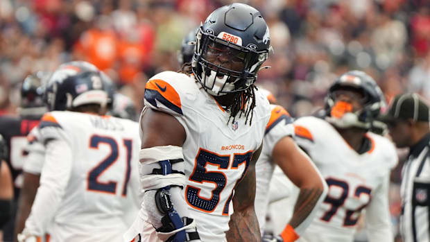 Denver Broncos linebacker Dre Greenlaw (57) reacts after a play during the first half against the Houston Texans.