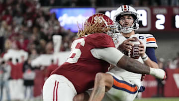 Nov 30, 2024; Tuscaloosa, Alabama, USA;  Alabama Crimson Tide defensive lineman Tim Keenan III (96) hits Auburn Tigers quarterback Payton Thorne (1)  for a loss during the second half at Bryant-Denny Stadium. Alabama won 28-14. Mandatory Credit: Gary Cosby Jr.-Imagn Images