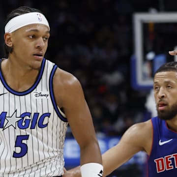 Oct 29, 2025; Detroit, Michigan, USA; Orlando Magic forward Paolo Banchero (5) dribbles while defended by Detroit Pistons guard Cade Cunningham (2) in the first half at Little Caesars Arena. Mandatory Credit: Rick Osentoski-Imagn Images