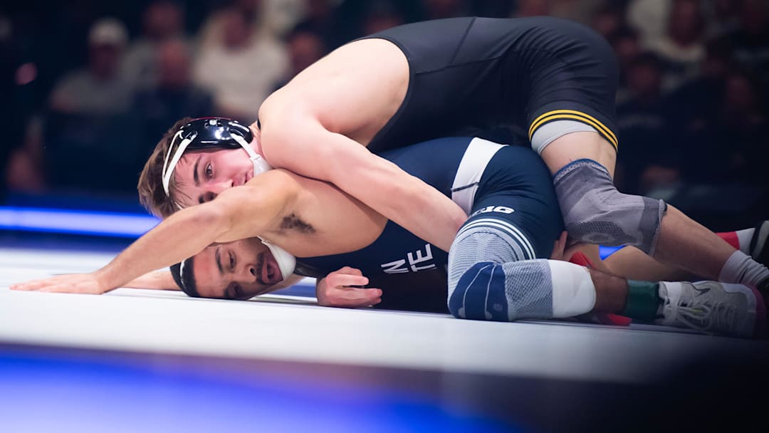 Iowa's Drake Ayala, top, wrestles Penn State’s Kurt McHenry in the 133-pound bout on January 31, 2025, in State College, Pa. The Nittany Lions won 30-8.