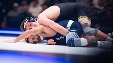 Iowa's Drake Ayala, top, wrestles Penn State’s Kurt McHenry in the 133-pound bout on January 31, 2025, in State College, Pa. The Nittany Lions won 30-8.