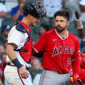 Jul 2, 2025; Atlanta, Georgia, USA; Atlanta Braves catcher Sean Murphy (12) hugs Los Angeles Angels catcher Travis d'Arnaud (25) before an at bat in the first inning at Truist Park. Mandatory Credit: Brett Davis-Imagn Images
