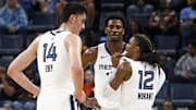 Oct 30, 2024; Memphis, Tennessee, USA; Memphis Grizzlies guard Ja Morant (12) talks with center Zach Edey (14) and forward Jaren Jackson Jr. (13) during the first half against the Brooklyn Nets at FedExForum. Mandatory Credit: Petre Thomas-Imagn Images