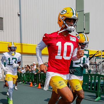 Green Bay Packers quarterback Jordan Love (10) runs onto the practice field during practice on Friday.