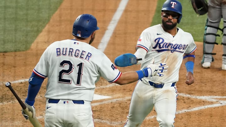 Apr 8, 2026; Arlington, Texas, USA; Texas Rangers shortstop Ezequiel Duran (20) slaps the hand of first baseman Jake Burger (21) after scoring during the fifth inning against the Seattle Mariners at Globe Life Field. Mandatory Credit: Raymond Carlin III-Imagn Images