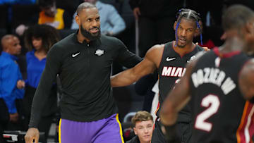Los Angeles Lakers forward LeBron James (23) and Miami Heat forward Jimmy Butler (22) greet each other following the game at the Kaseya Center.