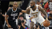 Nov 15, 2024; San Antonio, Texas, USA; Los Angeles Lakers forward LeBron James (23) looks to pass the ball while defended by San Antonio Spurs guard Chris Paul (3) during the first half during the first half at Frost Bank Center. Mandatory Credit: Scott Wachter-Imagn Images