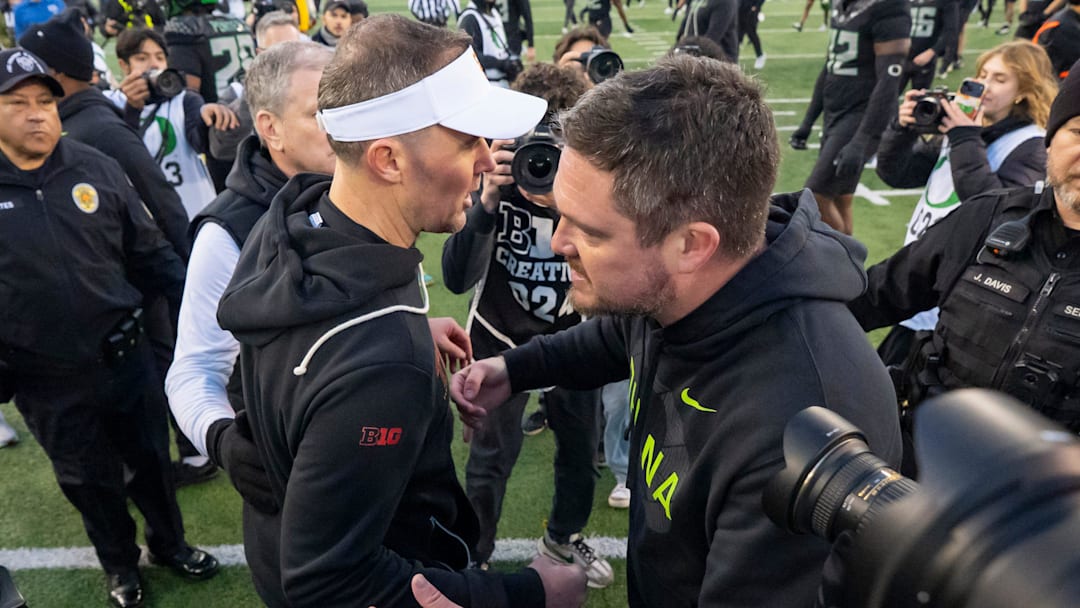 Oregon head coach Dan Lanning, right, and USC head coach Lincoln Riley shake hands postgame as the Oregon Ducks host the USC Trojans on Nov. 22, 2025, at Autzen Stadium in Eugene, Oregon.