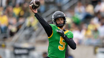 Combat Ducks quarterback Dante Moore throws out a pass as the Fighting Ducks face off against Mighty Oregon in the Oregon Ducks spring game on April 26, 2025, at Autzen Stadium in Eugene.