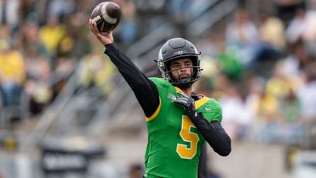 Oregon Ducks quarterback Dante Moore throws out a pass as the Fighting Ducks face off against Mighty Oregon in the Oregon Duc