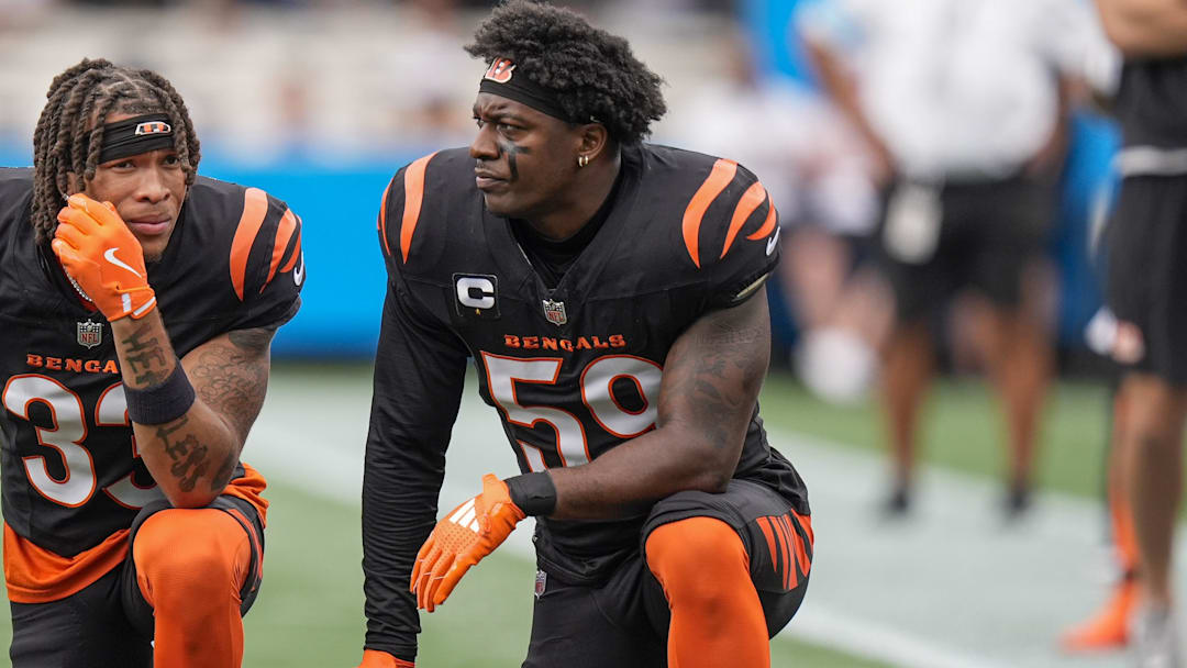 Sep 29, 2024; Charlotte, North Carolina, USA; Cincinnati Bengals safety Daijahn Anthony (33) and linebacker Akeem Davis-Gaither (59) take a knee for an injured player against the Carolina Panthers during 1st quarter at Bank of America Stadium. Mandatory Credit: Jim Dedmon-Imagn Images