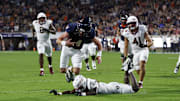 Sep 26, 2025; Charlottesville, Virginia, USA; Virginia Cavaliers quarterback Chandler Morris (4) scores a touchdown s Florida State Seminoles defensive back Ja'Bril Rawls (11) defends during the second quarter at Scott Stadium. Mandatory Credit: Geoff Burke-Imagn Images